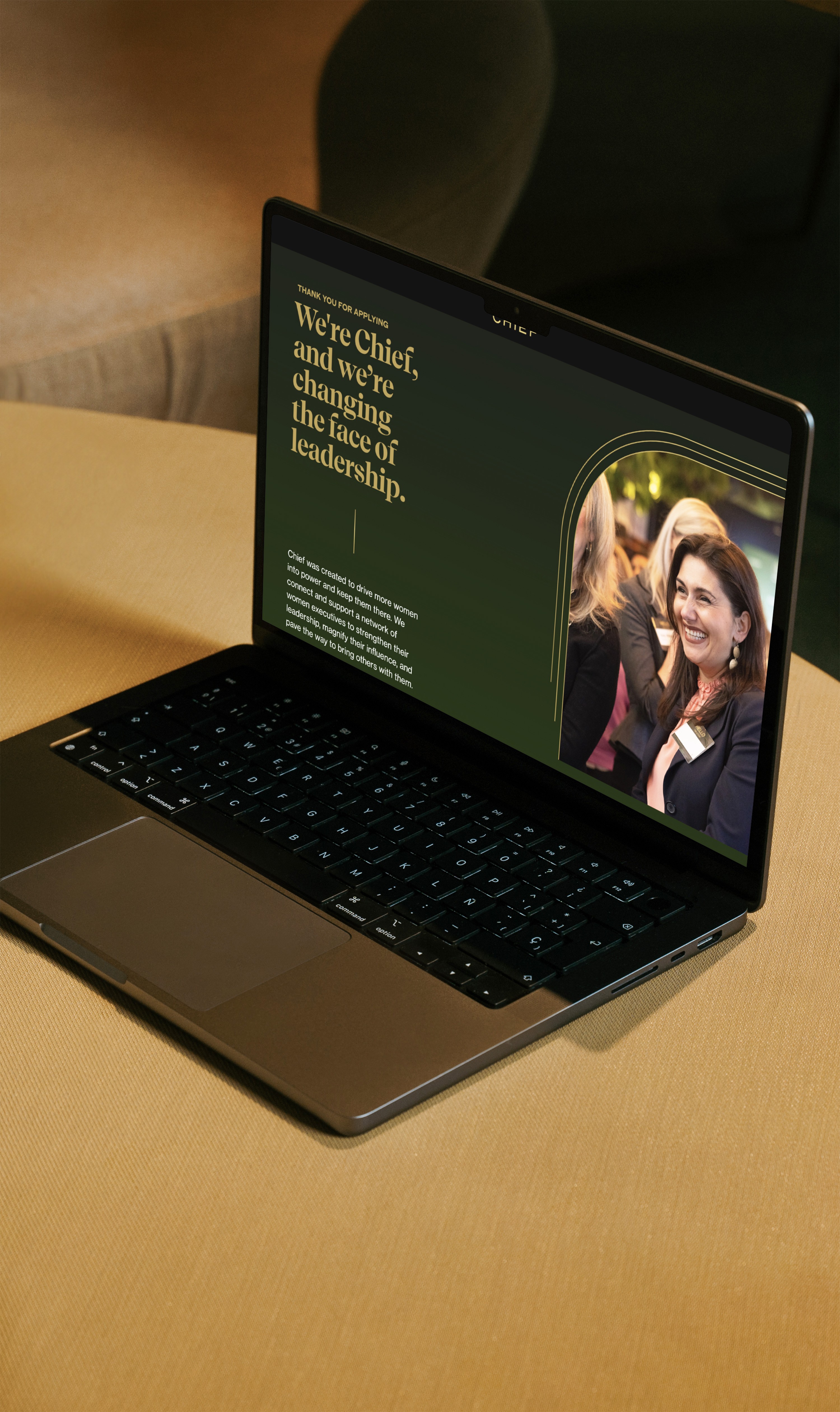 A computer on top of a table with one of the landing pages open.